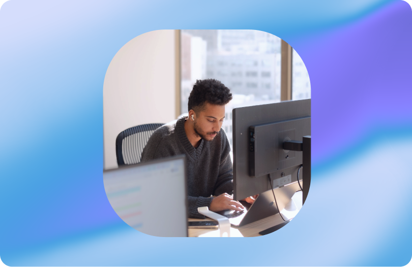 Person working at desk with monitor